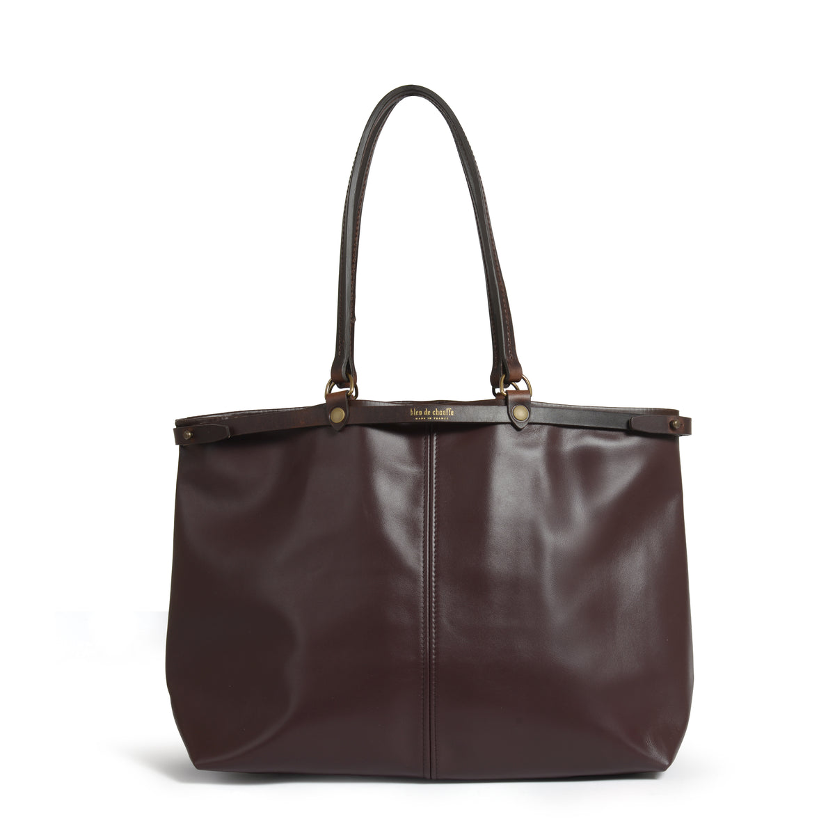 A dark brown leather tote bag with double shoulder straps and gold-tone hardware, photographed against a clean white background.