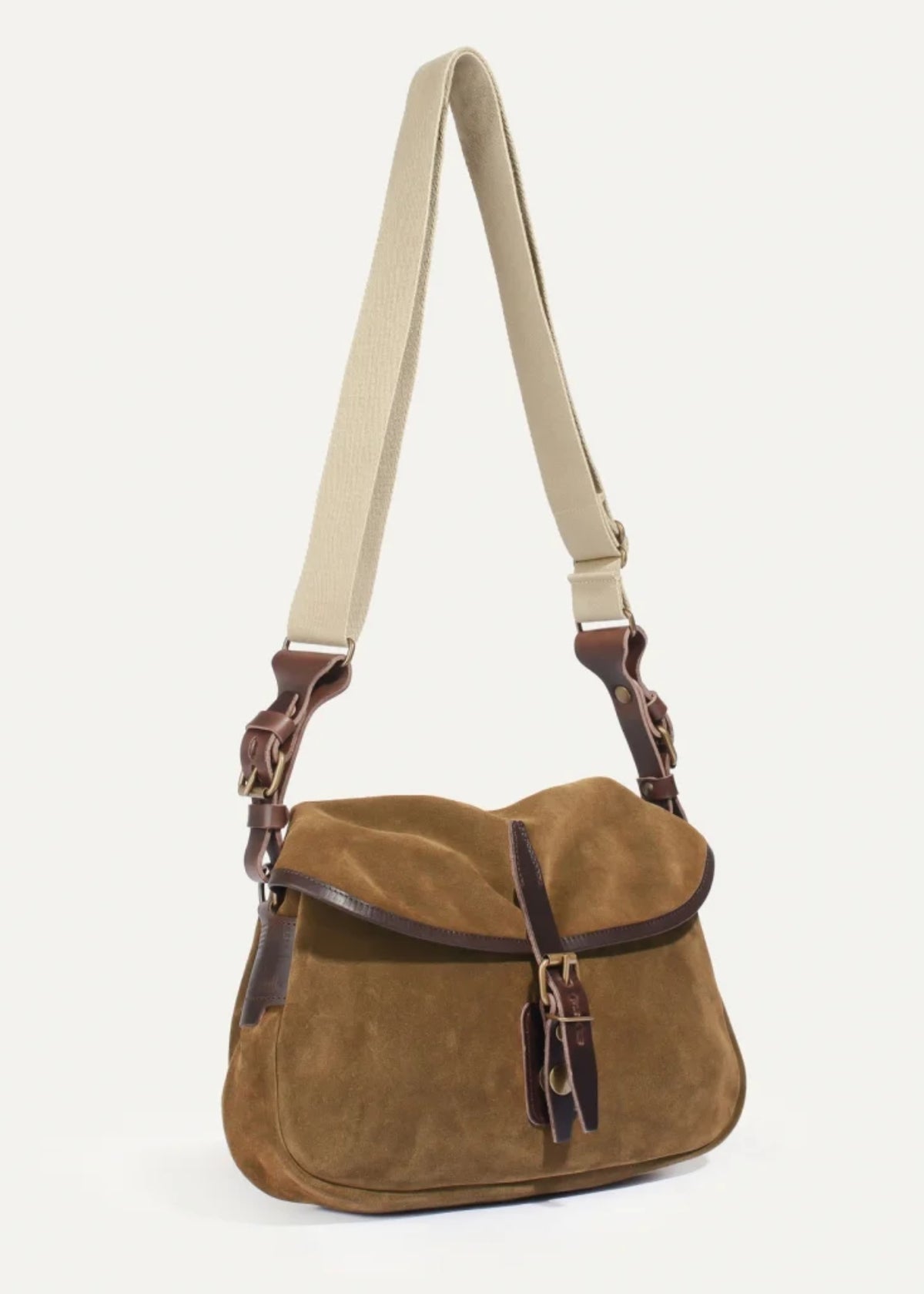A brown suede messenger bag with dark brown leather trim and a beige adjustable shoulder strap, shown against a plain off-white background.